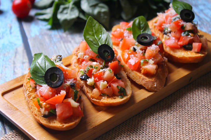Coal-fired bruschetta with tomatoes and basil on toasted bread