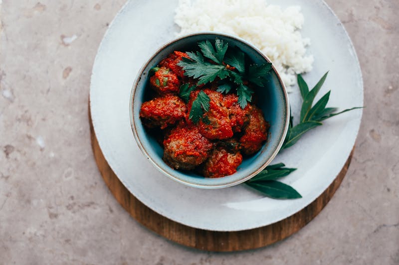 Meatballs in rich tomato sauce with fresh herbs