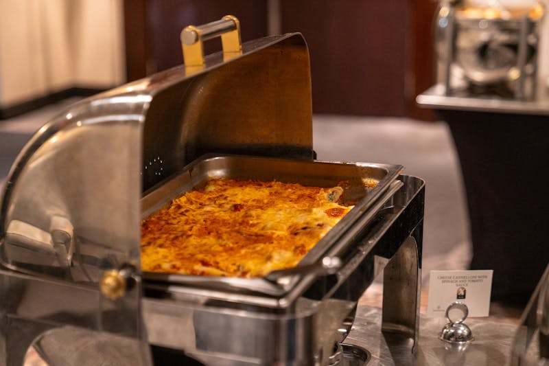 Corporate catering setup with assorted pizzas and sides